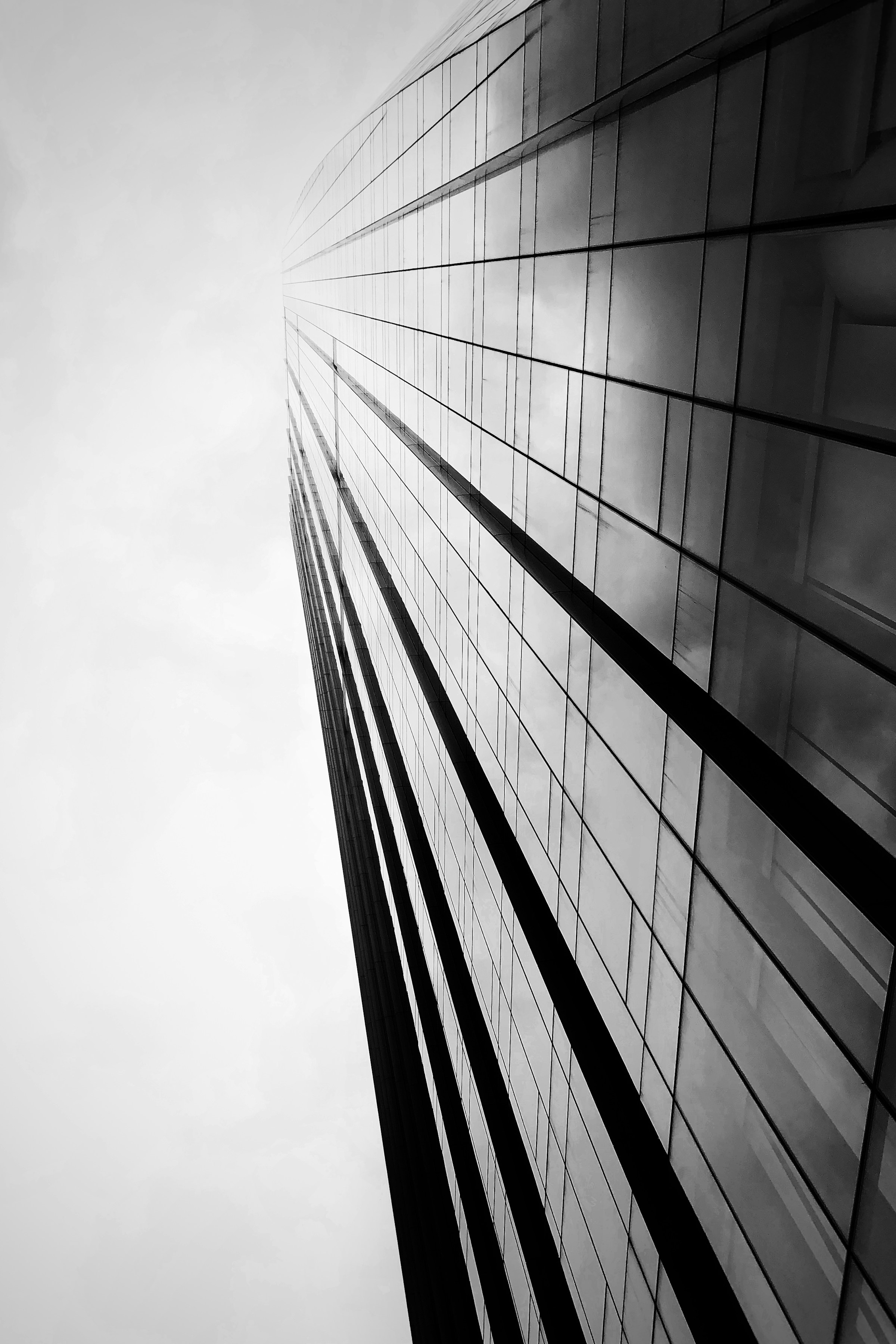Glass office tower rising toward the sky